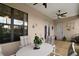Covered patio has neutral colored furniture, tile floors, ceiling fans and access to the backyard at 12169 Se 172Nd Ln, Summerfield, FL 34491