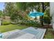 Outdoor deck with lounge chairs and a hammock invites relaxation among the trees and greenery at 12335 Se 130Th Ct, Ocklawaha, FL 32179