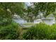 Tranquil backyard featuring a comfortable hammock and multiple lounge areas for relaxation and enjoyment at 12335 Se 130Th Ct, Ocklawaha, FL 32179