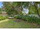 Lush backyard featuring a hammock, mature landscaping, and a fire pit for relaxing outdoors at 12335 Se 130Th Ct, Ocklawaha, FL 32179