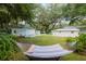 The backyard features a hammock and patio areas for serene relaxation amongst lush landscaping at 12335 Se 130Th Ct, Ocklawaha, FL 32179