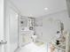 Well-lit bathroom featuring a walk-in shower, clean white tile, and updated vanity at 12335 Se 130Th Ct, Ocklawaha, FL 32179