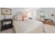 Well-lit bedroom featuring a comfortable bed, side tables, and a bright window at 12335 Se 130Th Ct, Ocklawaha, FL 32179