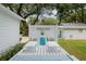 Exterior view of the deck showcases lounge chairs and bright cushions for enjoying the beautifully landscaped backyard at 12335 Se 130Th Ct, Ocklawaha, FL 32179