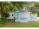 Outdoor deck features patio furniture and landscaping that create a tranquil escape in this backyard oasis at 12335 Se 130Th Ct, Ocklawaha, FL 32179