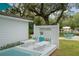 Deck with lounge chairs and pillows provides a relaxing view of the beautifully landscaped backyard at 12335 Se 130Th Ct, Ocklawaha, FL 32179