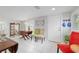 Inviting dining room featuring decor shelves, modern chairs, and white tile flooring at 12335 Se 130Th Ct, Ocklawaha, FL 32179
