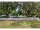 Charming home surrounded by mature trees and a white picket fence, offering a picturesque setting at 12335 Se 130Th Ct, Ocklawaha, FL 32179