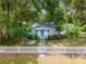Adorable home with a white picket fence, showcasing a lovely front yard and inviting curb appeal at 12335 Se 130Th Ct, Ocklawaha, FL 32179