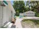 White home featuring front entrance, walkway, and a lovely outdoor dining area leading to the garage at 12335 Se 130Th Ct, Ocklawaha, FL 32179