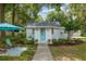 Inviting home features a bright blue door, lush landscaping, and cozy seating area at 12335 Se 130Th Ct, Ocklawaha, FL 32179