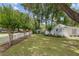 Lush front lawn showcasing mature trees and a charming seating area at 12335 Se 130Th Ct, Ocklawaha, FL 32179