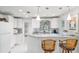 Bright kitchen with white cabinets, pendant lighting, and bar seating for a modern feel at 12335 Se 130Th Ct, Ocklawaha, FL 32179