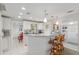 Well-lit kitchen with white cabinets, bar seating, and an open layout for easy entertaining at 12335 Se 130Th Ct, Ocklawaha, FL 32179