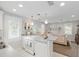 Open-concept kitchen with white cabinetry and a view to the adjacent living room at 12335 Se 130Th Ct, Ocklawaha, FL 32179
