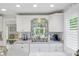 Bright kitchen featuring white cabinetry, modern appliances, and a view to the backyard at 12335 Se 130Th Ct, Ocklawaha, FL 32179