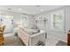 Well-lit living room with neutral décor, comfortable seating, and elegant accents, creating a welcoming and stylish atmosphere at 12335 Se 130Th Ct, Ocklawaha, FL 32179