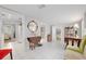 Bright living room featuring tile floors, unique furniture, and open access to other rooms at 12335 Se 130Th Ct, Ocklawaha, FL 32179