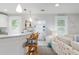 Open living space with bar seating flowing into a cozy living room, perfect for entertaining and relaxation at 12335 Se 130Th Ct, Ocklawaha, FL 32179