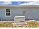 Exterior view of the house featuring a backup generator and a window at 12392 Sw 85 Pl, Dunnellon, FL 34432