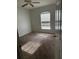 Bedroom featuring neutral carpet, a bright window, and simple white walls at 13155 Sw 73 Ave, Ocala, FL 34473