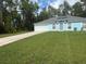 Charming single-story home with a well-manicured lawn, solar panels, and a long driveway at 13155 Sw 73 Ave, Ocala, FL 34473