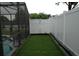 Well-maintained side yard with green grass, privacy fence, and access to the pool area at 14126 Greater Pines Blvd, Clermont, FL 34711