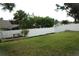 Spacious fenced backyard with green grass and garden area, perfect for outdoor activities at 14126 Greater Pines Blvd, Clermont, FL 34711
