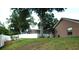 Expansive backyard with lush green lawn, mature trees, and a screened-in porch at 14126 Greater Pines Blvd, Clermont, FL 34711