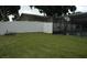 Lush, green backyard with an enclosed screened in pool at 14126 Greater Pines Blvd, Clermont, FL 34711
