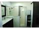 Bathroom featuring a glass shower enclosure, marble vanity top, and storage space for towels at 14126 Greater Pines Blvd, Clermont, FL 34711