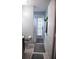 Full bathroom with a walk-in shower, toilet and access to the backyard via a white-door at 14126 Greater Pines Blvd, Clermont, FL 34711