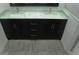 Elegant double sink vanity with marble countertop and sleek dark wood cabinetry in a well-lit bathroom at 14126 Greater Pines Blvd, Clermont, FL 34711