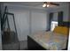 Bright bedroom features gray walls, white closets, and a decorative yellow patterned bedspread at 14126 Greater Pines Blvd, Clermont, FL 34711