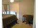 Bedroom showcasing a wooden bed frame, plush carpeting, and a well-lit window with neutral curtains at 14126 Greater Pines Blvd, Clermont, FL 34711