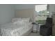 Cozy bedroom features a chair, side table, and a plush bed with a decorative headboard and pillows at 14126 Greater Pines Blvd, Clermont, FL 34711
