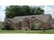 Charming single-story home with well-maintained landscaping and an inviting arched entryway at 14126 Greater Pines Blvd, Clermont, FL 34711