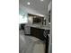 Kitchen showcases a marble countertop and sleek stainless steel appliances, seamlessly connecting to the living area at 14126 Greater Pines Blvd, Clermont, FL 34711