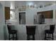 Open kitchen features a counter with bar seating and stainless steel appliances at 14126 Greater Pines Blvd, Clermont, FL 34711
