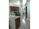 Well-lit kitchen with modern appliances and wooden cabinets overlooks the dining area at 14126 Greater Pines Blvd, Clermont, FL 34711