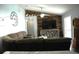 Inviting living room featuring a cozy brown sofa and a stylish wood-paneled wall with a mounted TV at 14126 Greater Pines Blvd, Clermont, FL 34711