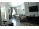 Open-concept living room with a dining area, dark cabinet, and comfortable seating arrangement at 14126 Greater Pines Blvd, Clermont, FL 34711