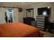 Comfortable bedroom with closet, dresser, and tv at 14126 Greater Pines Blvd, Clermont, FL 34711