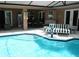 Sparkling pool featuring a beach volleyball net, covered patio, and a comfortable lounging area at 14126 Greater Pines Blvd, Clermont, FL 34711