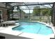 Screened-in pool area with a volleyball net, lounge furniture, and view of the backyard at 14126 Greater Pines Blvd, Clermont, FL 34711