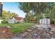 View of the home's backyard with multiple storage sheds and green house at 1434 Se Silver Springs Pl, Ocala, FL 34471