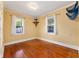 Sun-lit bedroom boasting hardwood floors and dual windows with views at 1434 Se Silver Springs Pl, Ocala, FL 34471