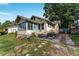 Exterior of home with a small yard, sidewalk, and garden at 1434 Se Silver Springs Pl, Ocala, FL 34471