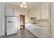 Bright kitchen featuring white cabinets and updated flooring at 1434 Se Silver Springs Pl, Ocala, FL 34471