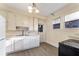 Traditional kitchen with white cabinets, stainless steel sink, and ample counter space at 1434 Se Silver Springs Pl, Ocala, FL 34471